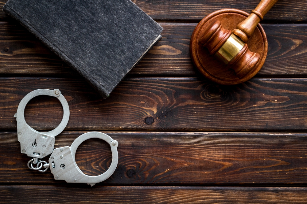 Lawyer reviewing legal documents to help client reduce criminal penalties and restore firearm rights.