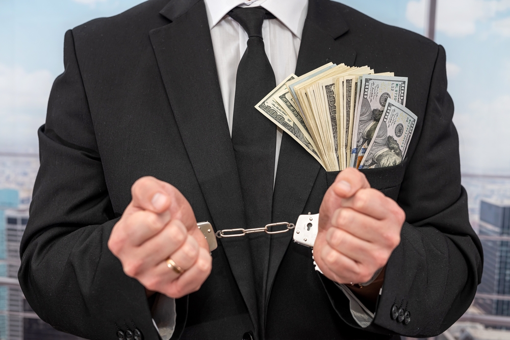 Gavel, handcuffs, and legal papers symbolizing penalties like jail time and fines after a criminal conviction.